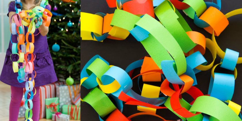 Girl holding colorful paper in front of a Christmas tree