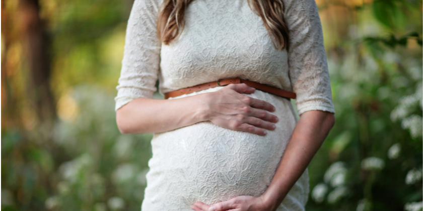 Woman holding belly during pregnancy 