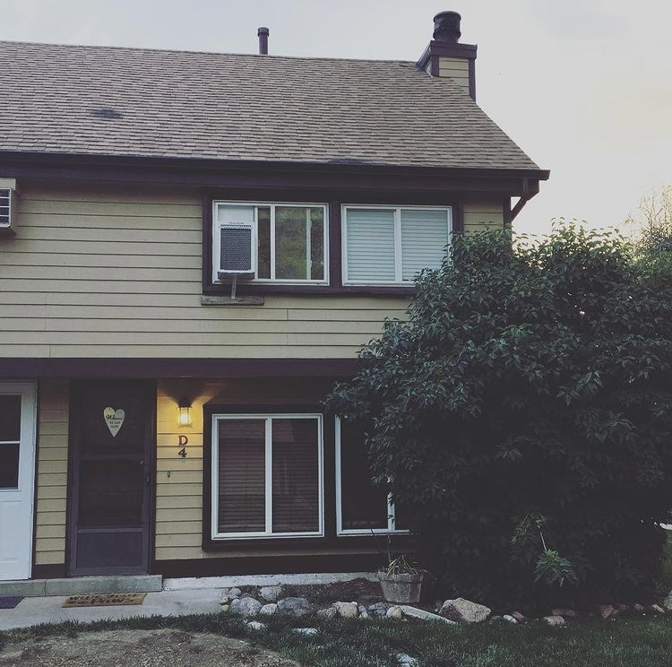 A photo of our first home together with the lilac bush featured on the right had side.